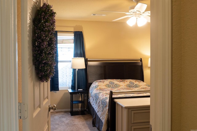 carpeted bedroom featuring visible vents, baseboards, and ceiling fan