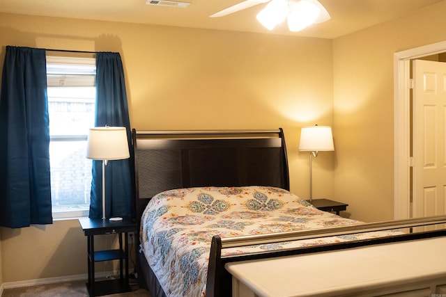 bedroom with visible vents, baseboards, carpet floors, and ceiling fan