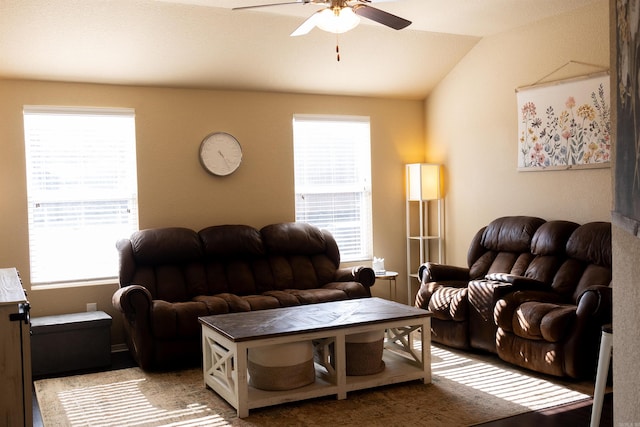 living area with vaulted ceiling, a wealth of natural light, and ceiling fan