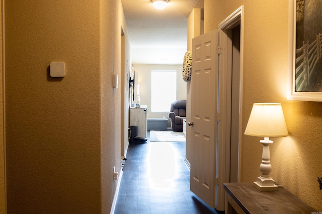 hallway featuring a textured wall