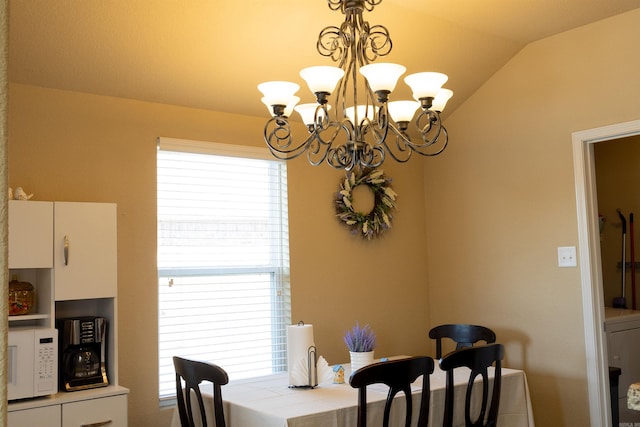 dining room featuring lofted ceiling, a wealth of natural light, and a chandelier