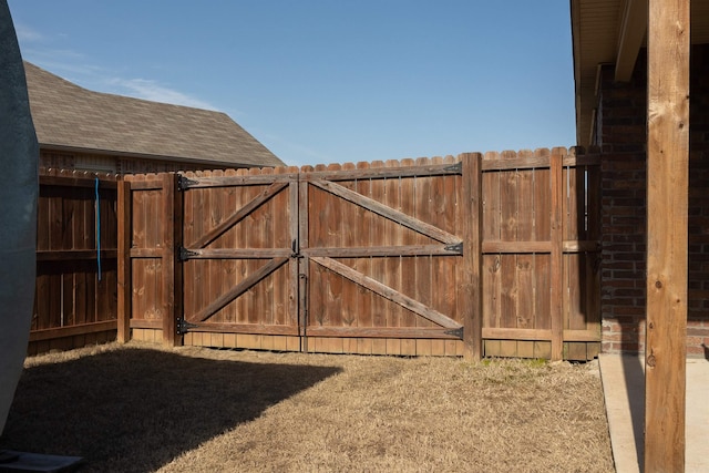 view of gate with fence