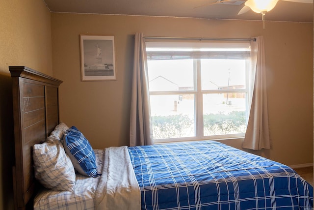 bedroom featuring a ceiling fan and baseboards