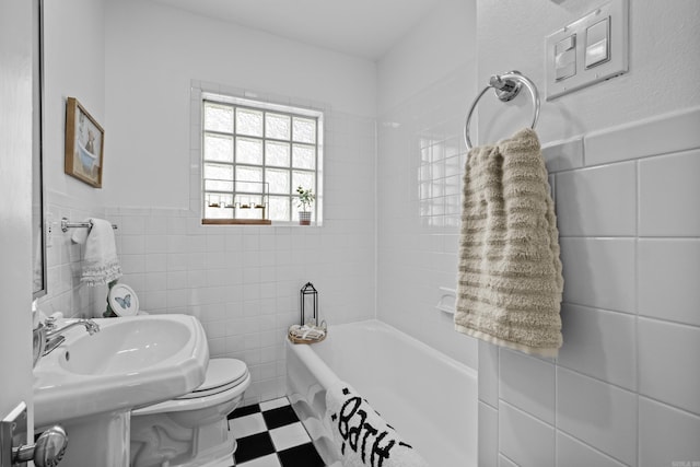 full bathroom with tile patterned floors, a bathtub, tile walls, and toilet