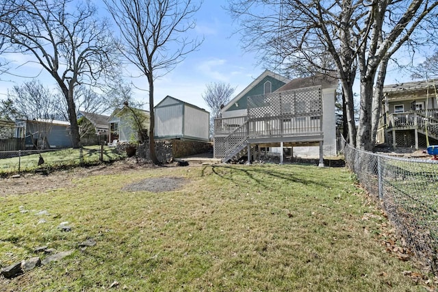 view of yard featuring stairs, a deck, and a fenced backyard