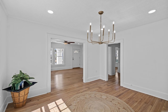 dining room with wood finished floors, baseboards, and ornamental molding