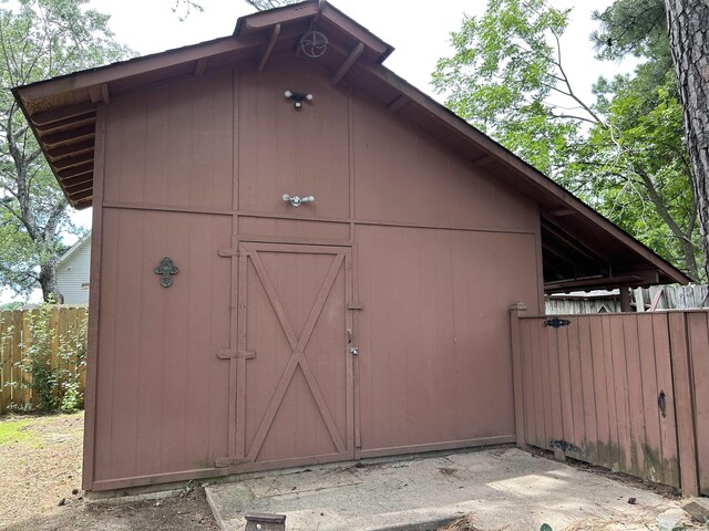 view of shed featuring fence