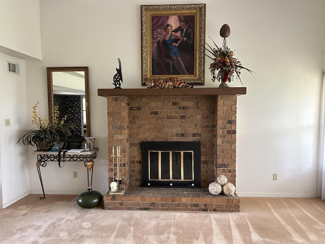 details featuring visible vents, a fireplace, baseboards, and carpet