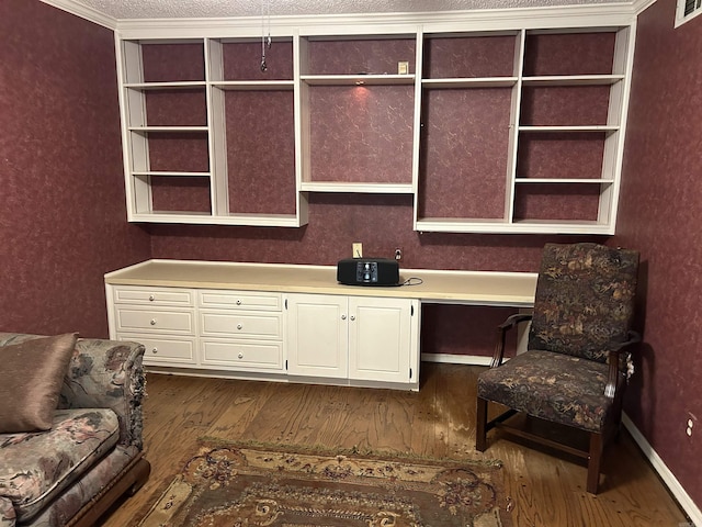 office space featuring visible vents, a textured ceiling, dark wood-style floors, and built in study area