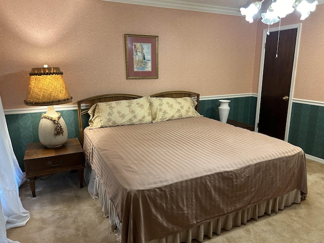 carpeted bedroom with wainscoting, wallpapered walls, and ornamental molding