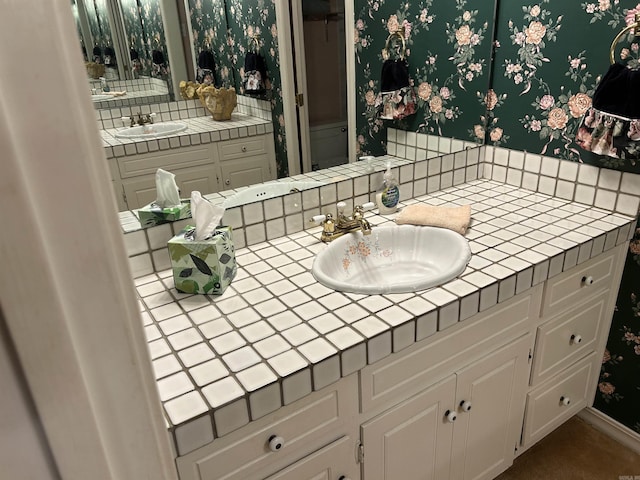 bathroom with tasteful backsplash, vanity, and wallpapered walls