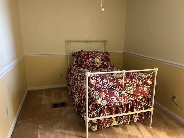 carpeted bedroom with visible vents and baseboards