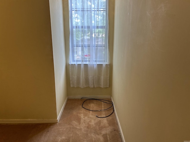 carpeted spare room with baseboards