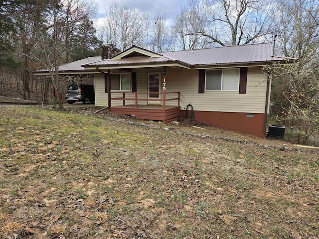 single story home featuring an attached carport, a porch, a chimney, crawl space, and metal roof