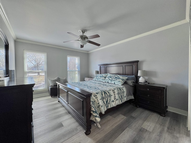 bedroom featuring baseboards, light wood-style floors, ceiling fan, and crown molding