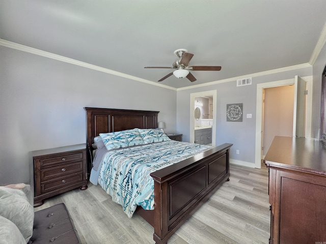 bedroom featuring visible vents, crown molding, light wood-type flooring, and baseboards