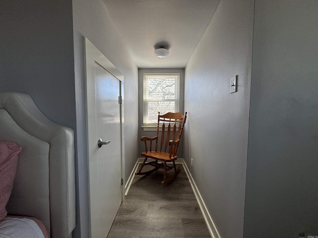 hall with wood finished floors and baseboards