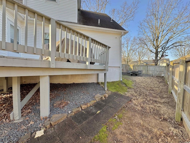 wooden deck with a fenced backyard