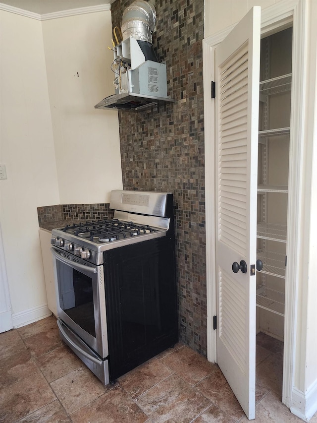 kitchen with open shelves, baseboards, stainless steel gas stove, and stone tile flooring