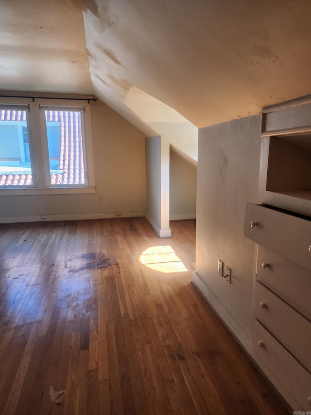 bonus room with hardwood / wood-style flooring, baseboards, and lofted ceiling