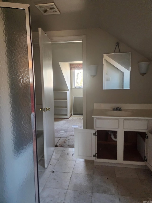 bathroom with vanity, vaulted ceiling, and visible vents