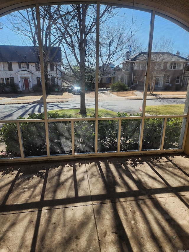 unfurnished sunroom featuring a residential view