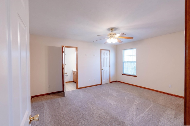 unfurnished room featuring light colored carpet, baseboards, and ceiling fan