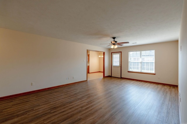 spare room with a ceiling fan, baseboards, and wood finished floors