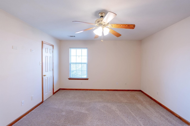 unfurnished room with visible vents, light colored carpet, baseboards, and ceiling fan