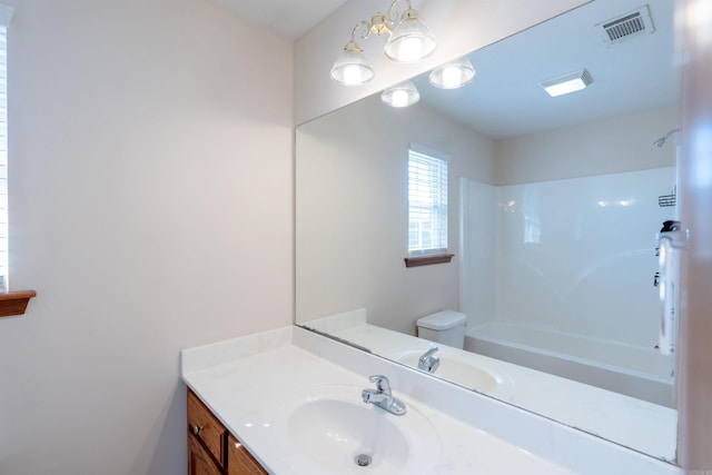 full bath featuring visible vents, toilet, vanity, and shower / washtub combination