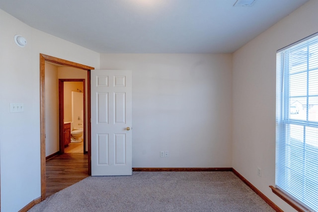 unfurnished room featuring baseboards and carpet