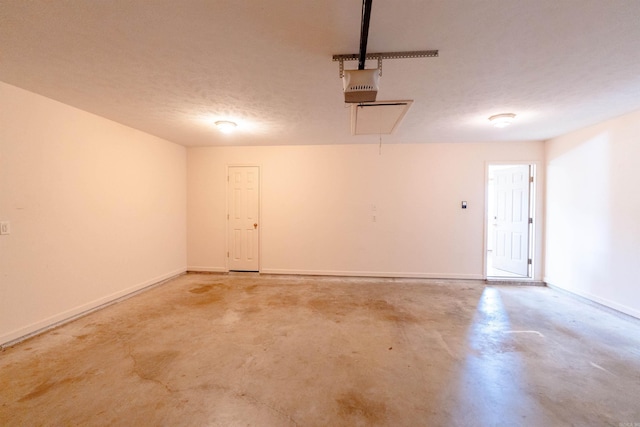 garage with baseboards and a garage door opener