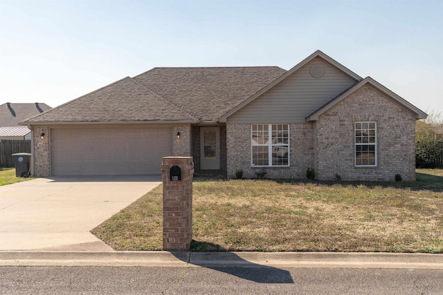 ranch-style home with driveway, a front lawn, roof with shingles, a garage, and brick siding