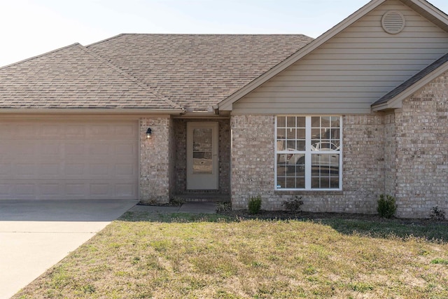 single story home featuring a front lawn, concrete driveway, an attached garage, and a shingled roof