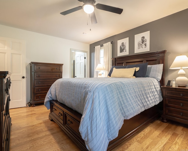 bedroom with light wood-type flooring and a ceiling fan