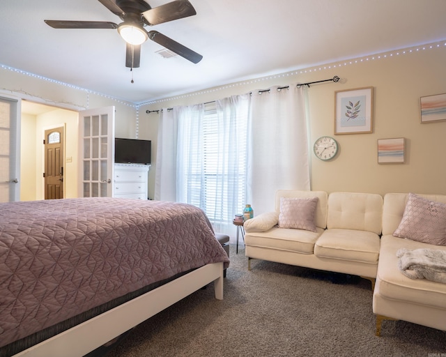 bedroom with visible vents, carpet flooring, and a ceiling fan