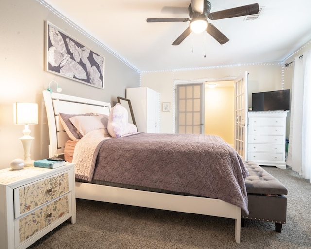 bedroom with crown molding, a ceiling fan, visible vents, and carpet floors