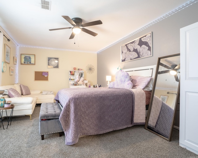 carpeted bedroom featuring ceiling fan, visible vents, and ornamental molding