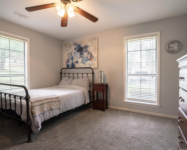 carpeted bedroom featuring visible vents, baseboards, and a ceiling fan