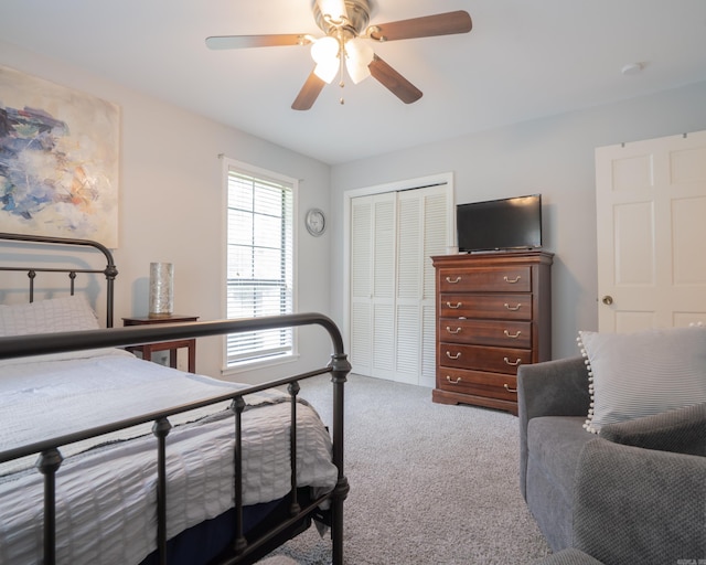 bedroom with a ceiling fan, a closet, and carpet floors