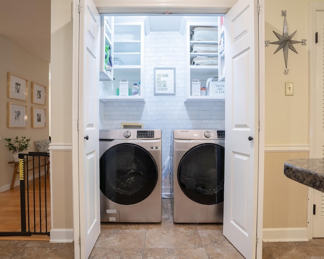 washroom with washing machine and dryer and laundry area