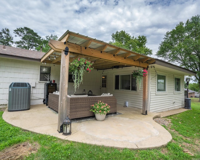 back of property featuring a patio area, an attached carport, cooling unit, and an outdoor hangout area