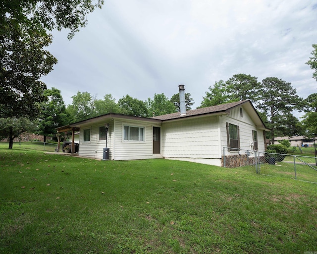 back of house with a yard and fence