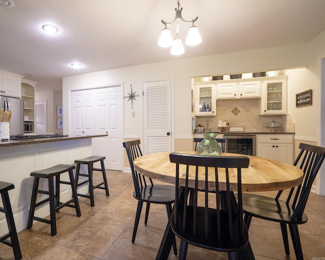 dining area with bar, recessed lighting, and beverage cooler