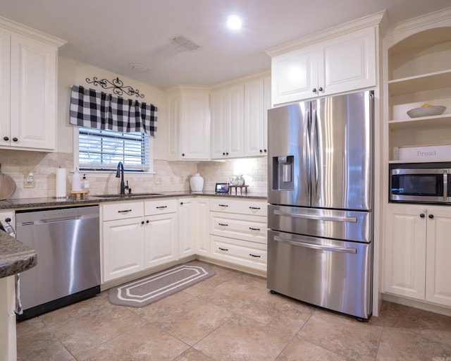 kitchen with a sink, stainless steel appliances, visible vents, and white cabinets