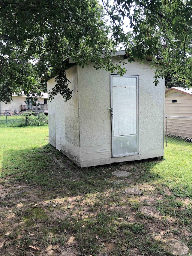 view of shed featuring fence