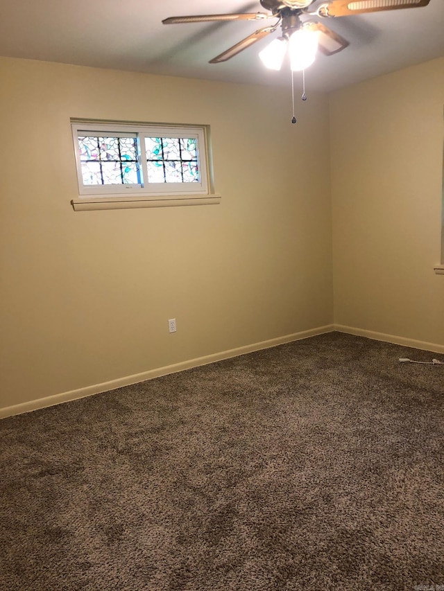 empty room with baseboards, a ceiling fan, and carpet flooring