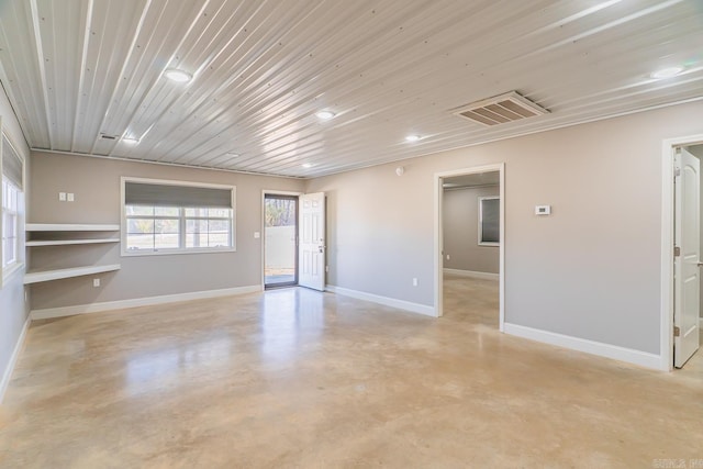 unfurnished room featuring wood ceiling, baseboards, visible vents, and concrete floors