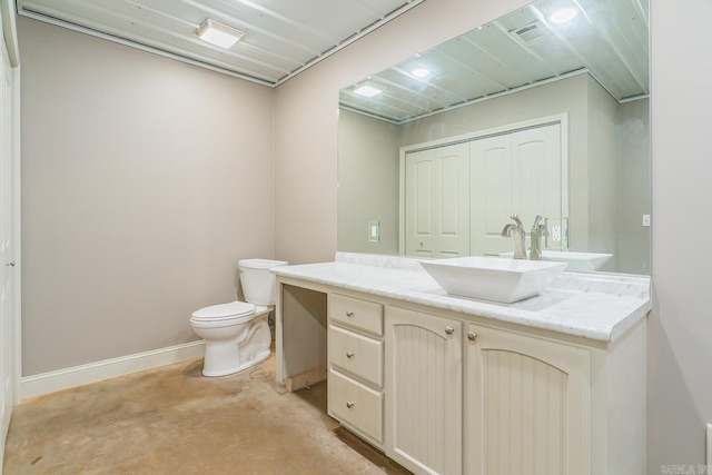 half bath with vanity, toilet, baseboards, and visible vents