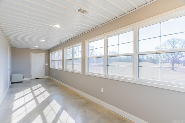 unfurnished sunroom featuring visible vents